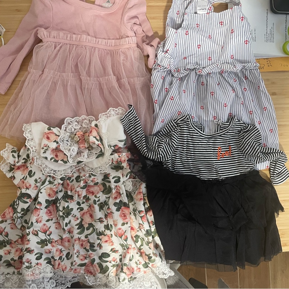 Assorted Baby Dresses in Pink, Black, and Floral